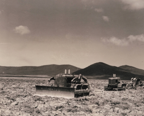 Bulldozers pulling ditching machine